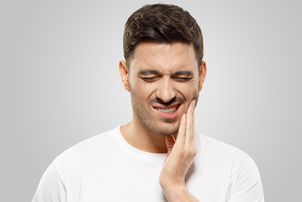 A man has tooth pain that requires root canal therapy